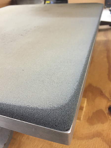 picture of a worn down corner of a heat press lower platen pad