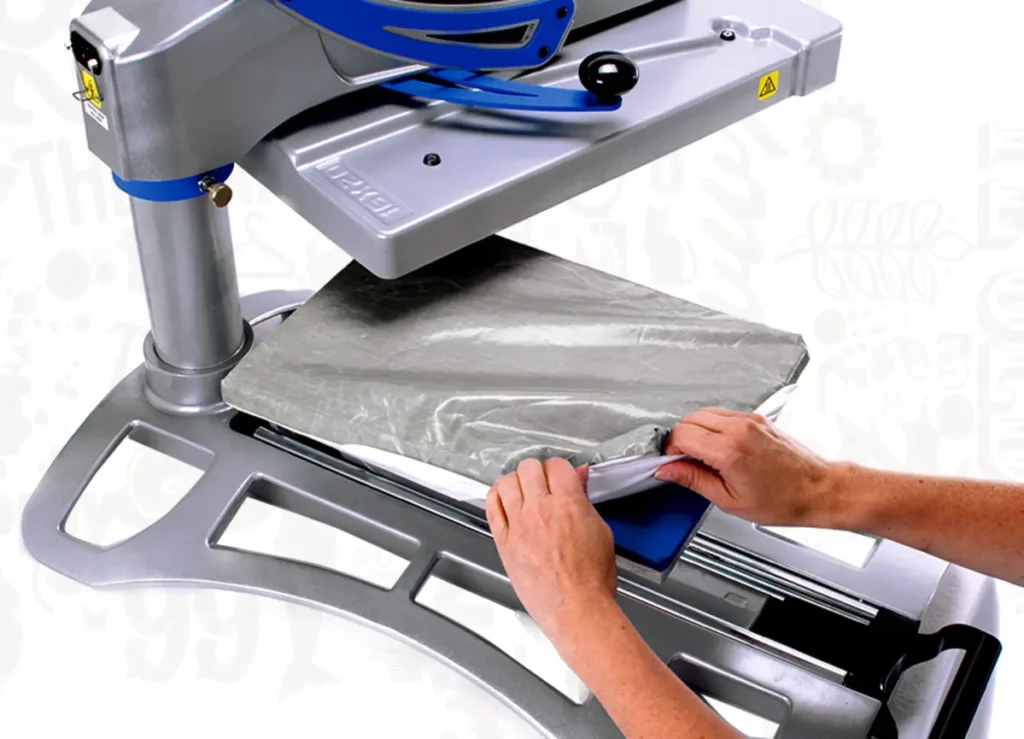 Picture of a Lower Platen Protector being put on to a heat press