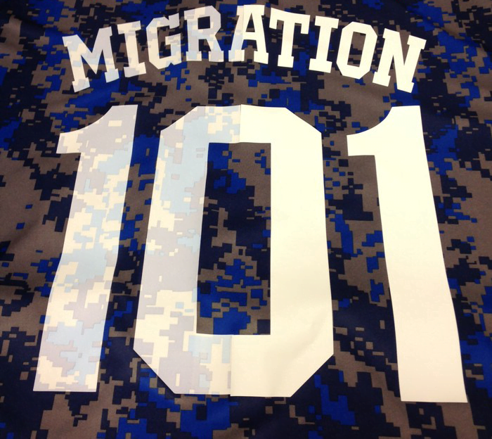 picture of white heat transfer vinyl on a dye sublimated jersey, with the jersey color bleeding through the white vinyl